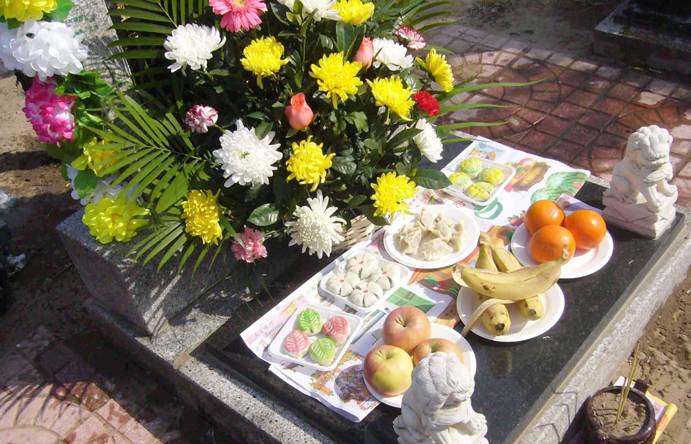 为逝去的亲人送上一束鲜花，摆满祭祀的食物